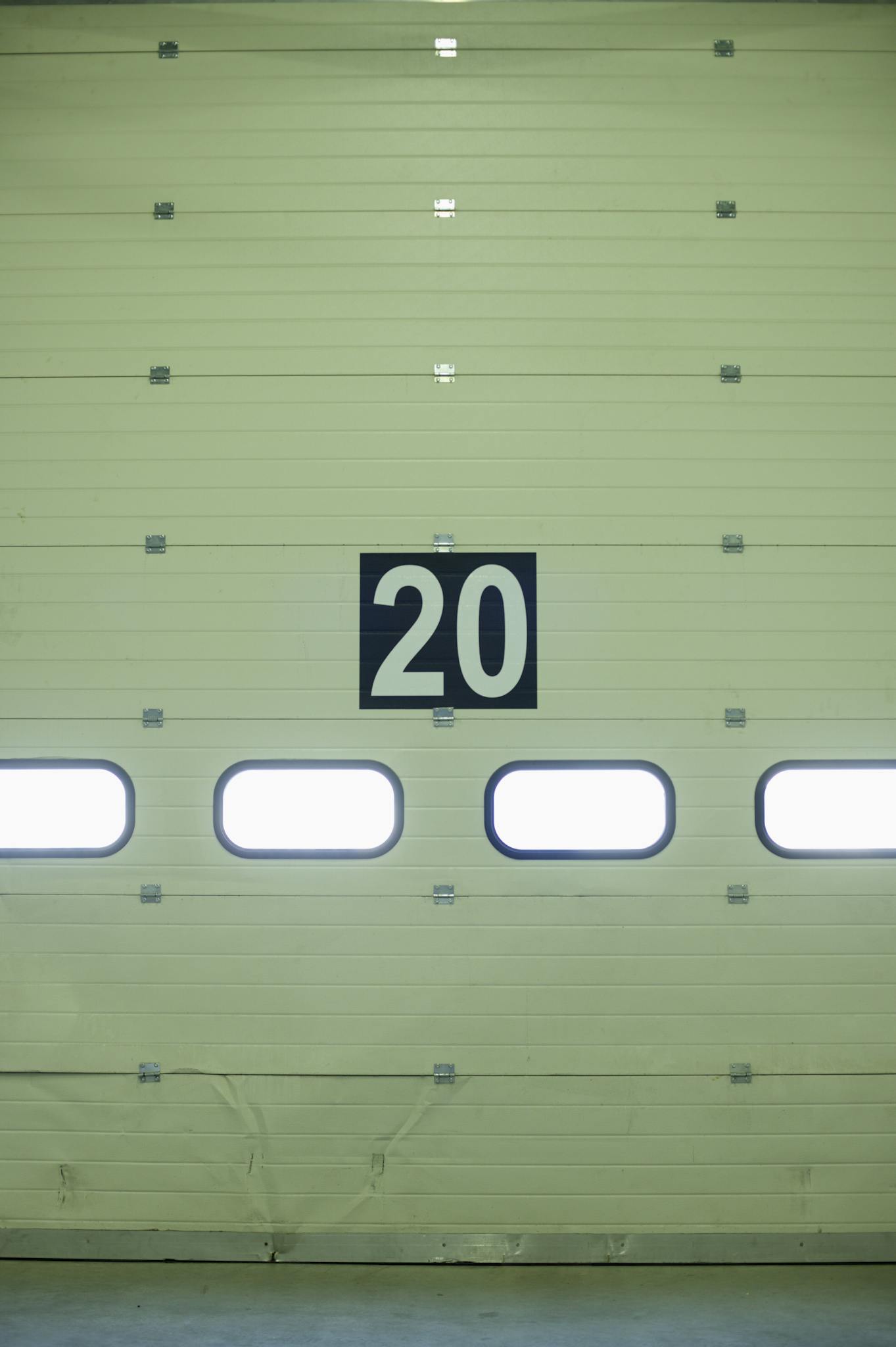 Close-up of a large industrial garage door marked with the number 20.